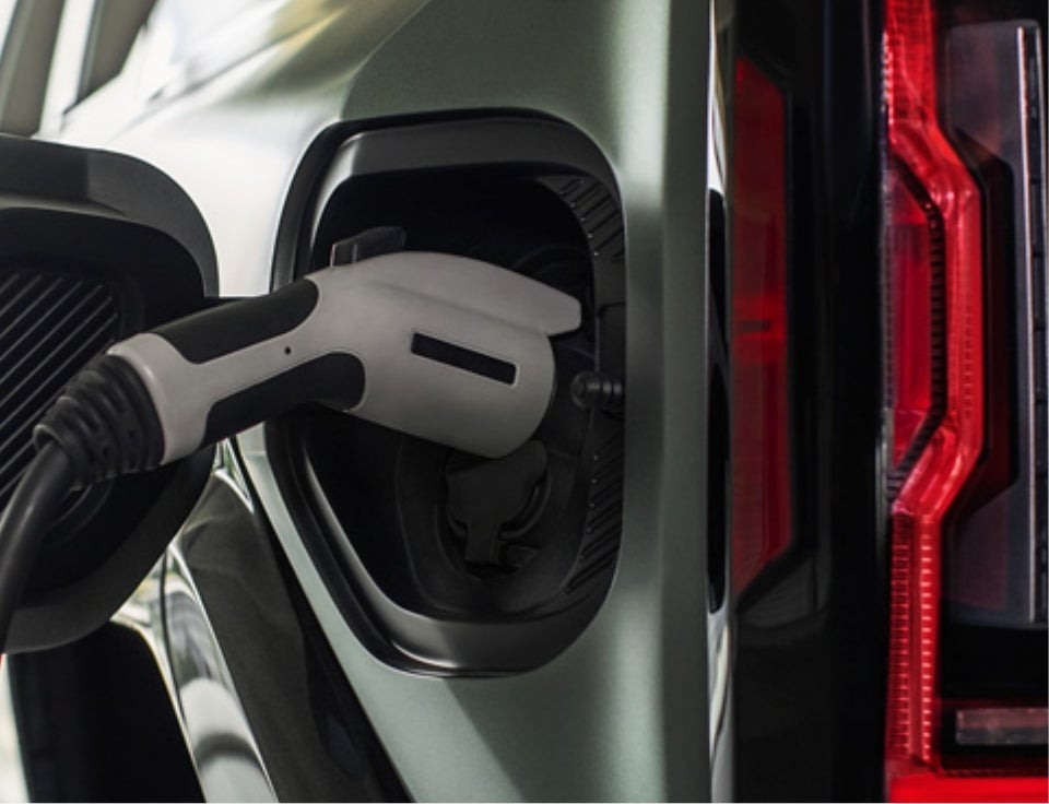 Close up of charging port with charger plugged in on a GMC Hummer EV SUV - Peitz GMC-Service Inc. in HARTINGTON NE